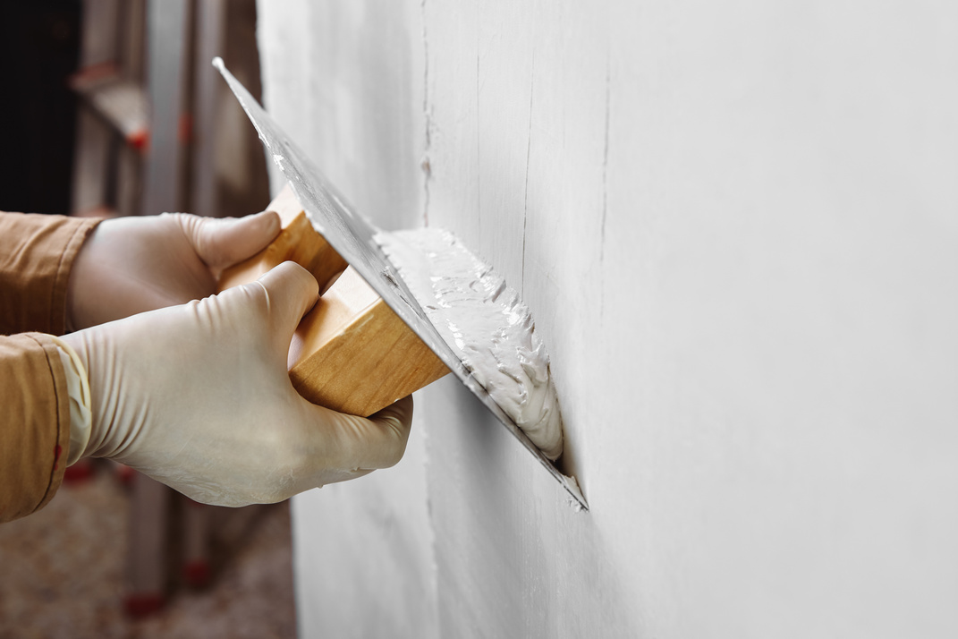 Plastering and smoothing wall